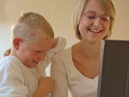 Effects of video games - boy and mother on laptop